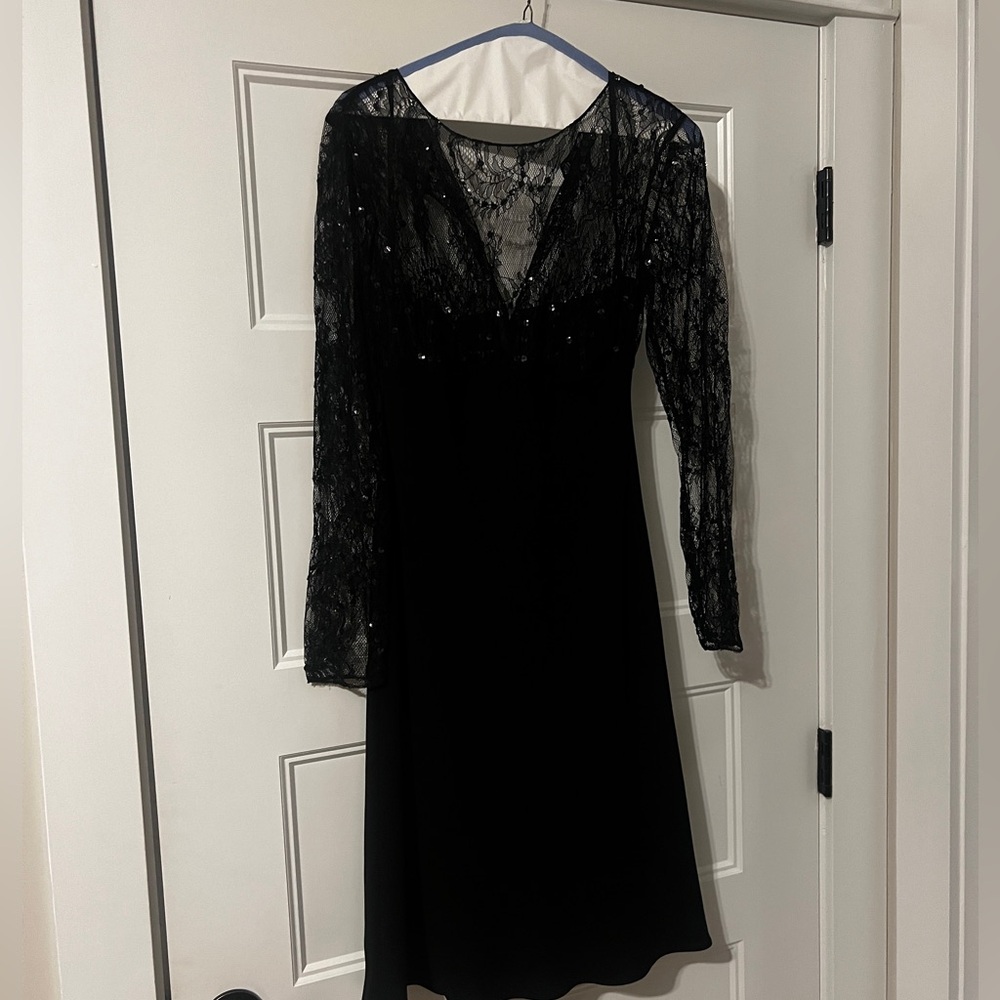 Black dress with lace sequin long sleeves. Knee length.